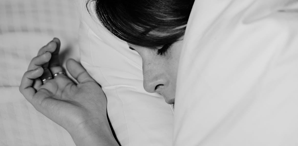 Close-up of a person sleeping peacefully, captured in monochrome for a serene feel.