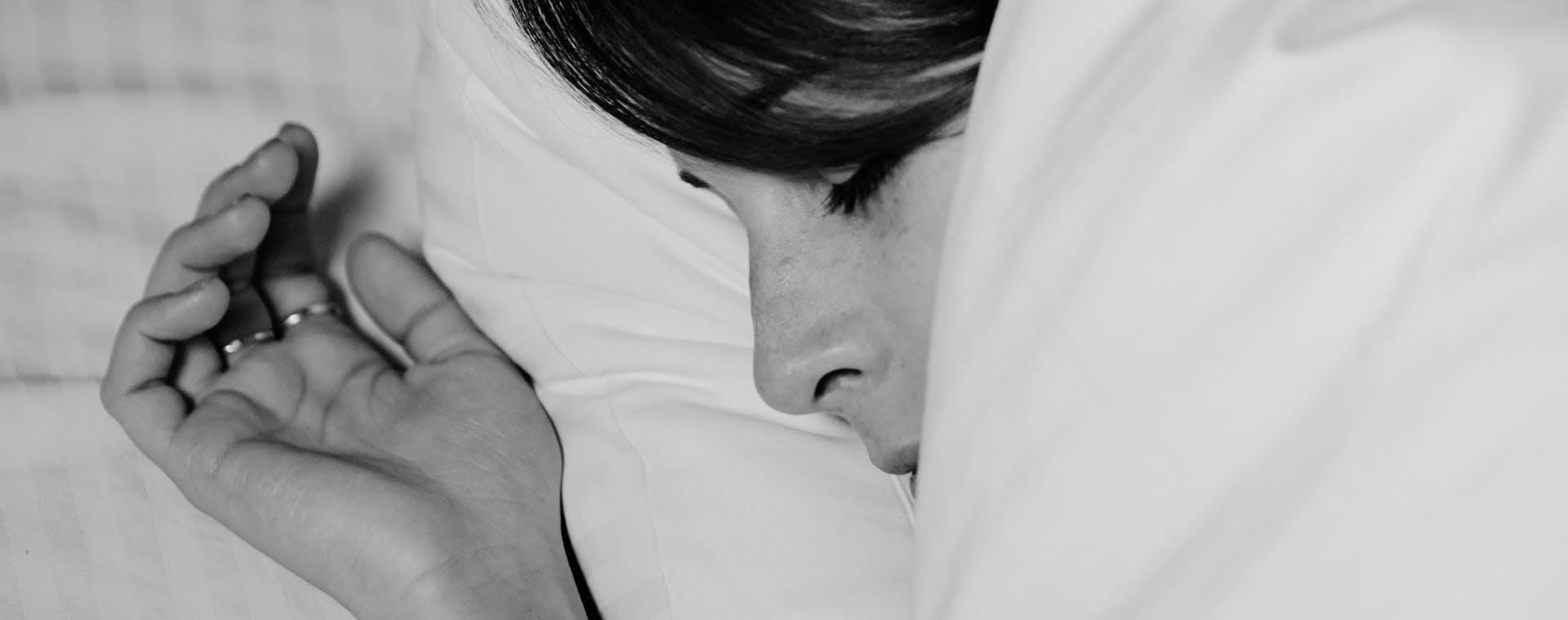 Close-up of a person sleeping peacefully, captured in monochrome for a serene feel.