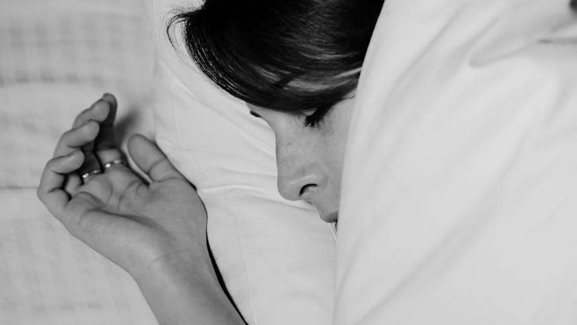 Close-up of a person sleeping peacefully, captured in monochrome for a serene feel.